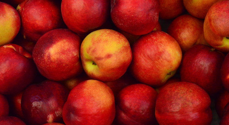 Aerial view of cluster of red apples with yellow highlights that help keep teeth clean with fibrous texture