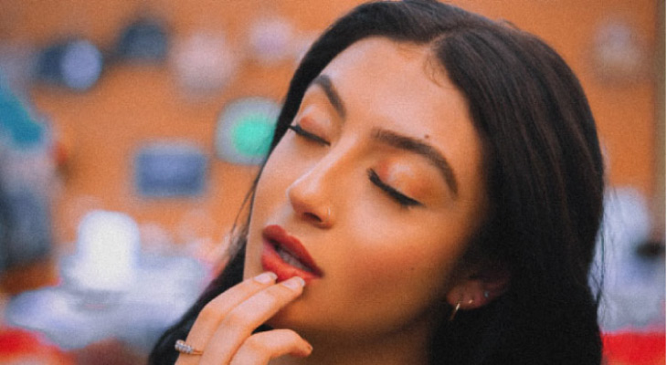 woman touching her lower lip wondering if her gums are receding