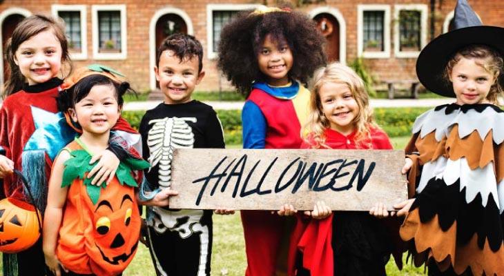 group of kids dressed up for halloween trick or treat