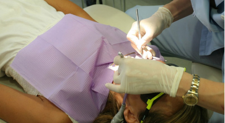 patient in the dentist's chair undergoing root canal therapy