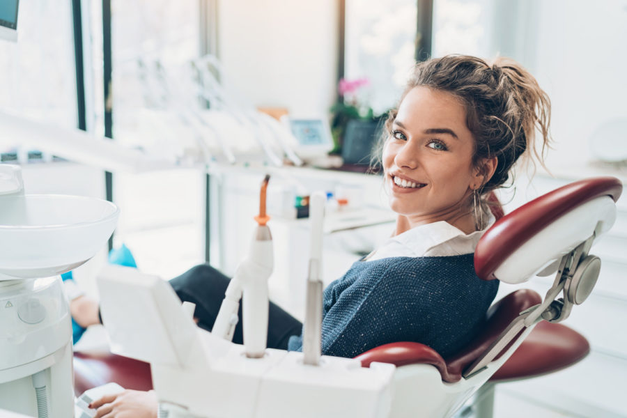 Brunette woman smiles before receiving root canal therapy in Temple Terrace, FL