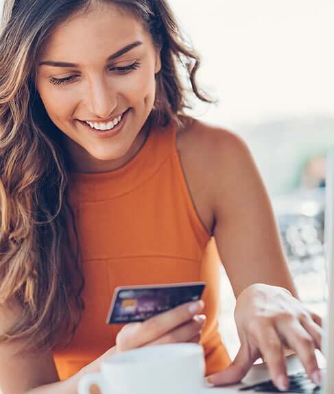 woman smiling with credit card