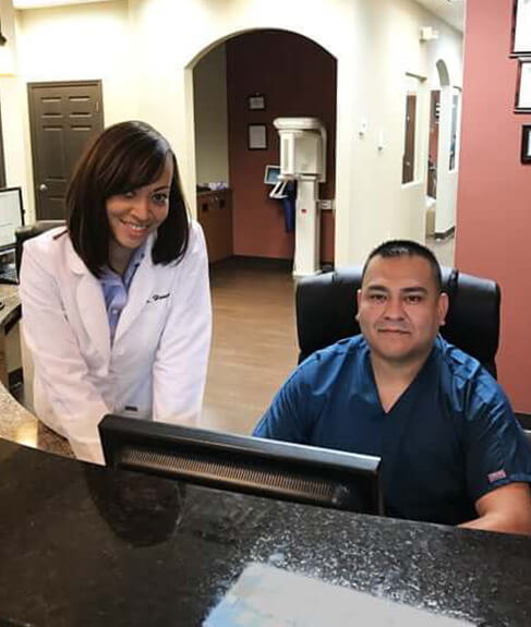 Dr with front desk associate