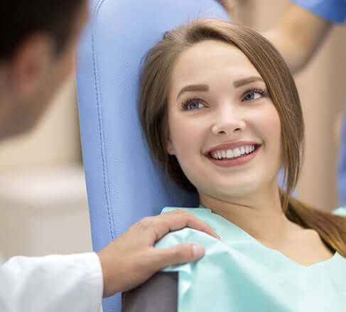 smiling woman in dental chair