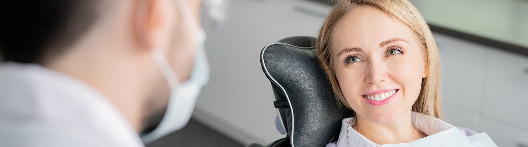 Woman smiling at dentist from exam chair