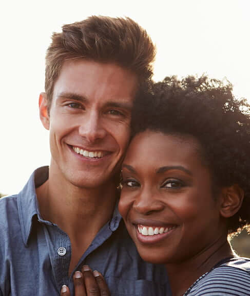 man and woman smiling together