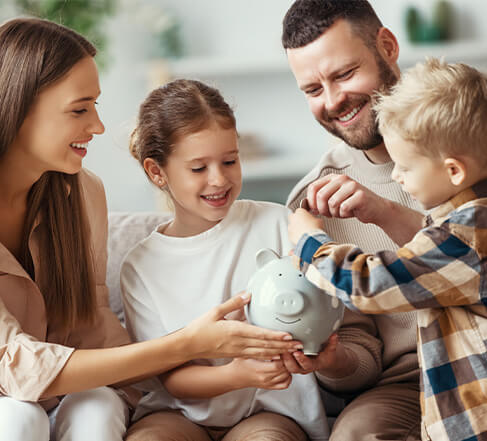 family saving money in piggy bank